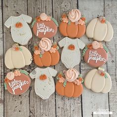 baby shower cookies decorated like pumpkins and onesuits with the words little pumpkin on them