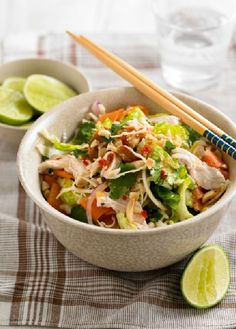 a white bowl filled with salad and chopsticks