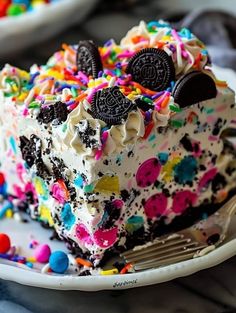 an oreo cookie cake on a plate with sprinkles and chocolate chips