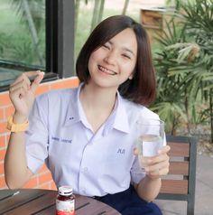 a woman sitting at a table with a glass of water