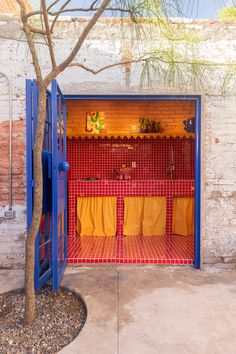 an open blue door with yellow towels hanging from it's sides and on the outside