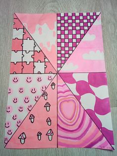 a piece of paper that has been made into a quilt with pink and white designs on it