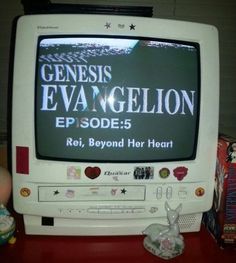 an old television sitting on top of a red table