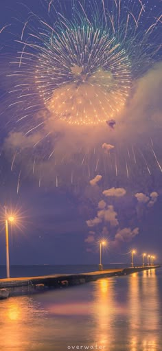 fireworks are lit up in the sky above water