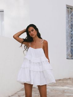 Elevate your summer wardrobe with this stunning women's layered ruffle mini dress. Designed with a backless spaghetti strap style, this 100% cotton dress offers both comfort and elegance. Its versatile design makes it a perfect choice for various occasions, from festive events to everyday wear. Key Features: Premium Fabric: Made from 100% cotton, ensuring a soft, breathable, and comfortable feel against the skin. Chic Design: Features multiple layers of ruffles, creating a playful yet sophistica Summer Cotton Mini Suspender Dress, Summer Cotton Suspender Dress Mini Length, Summer Cotton Suspender Mini Dress, Cotton Suspender Dress For Summer Vacation, Cotton Suspender Dress For Summer, Cotton Suspender Dress With Adjustable Straps For Beach, Summer Tiered Sundress With Adjustable Straps, Summer Beach Suspender Dress With Ruffled Straps, Summer Cotton Suspender Dress With Adjustable Straps