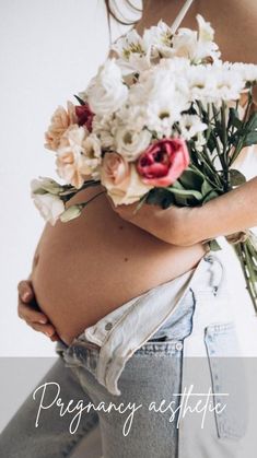 a pregnant woman holding flowers in her belly