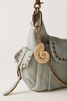 Add a sea-inspired touch to every style with this stunning bag charm featured in a shell silhouette and worn metal fabrication for a true lived-in look. | Solid Shell Bag Charm by Free People in Gold Free People Bag, Shell Silhouette, 2025 Trends, Art Deco Wall Art, Mermaid Kisses, Free People Bags, Shell Bag, Pandora Avatar, Personal Style Inspiration