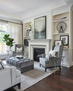 a living room filled with furniture and a fire place in the middle of a room