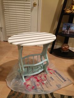 a small table that has been placed on top of a plastic bag in the middle of a room