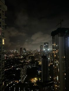 the city lights shine brightly at night from high up in the sky above skyscrapers