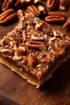 there are pecans on the table next to some bars that have been cut into squares