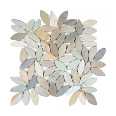 a pile of white and grey leaves on top of each other with some silver foil