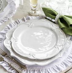 a table set with white plates and silverware