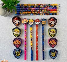 a bunch of pencils that are laying on the ground next to each other with cartoon characters on them