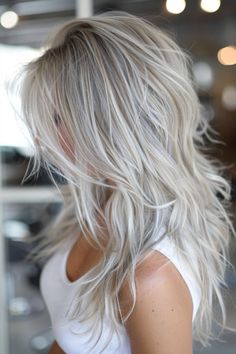 With its blend of cool tones, ash blonde hair color offers a sleek and modern appearance that flatters a range of skin tones. This versatile hue can be personalized with highlights or balayage for a chic, individualized style. Blonde Ash Hair Highlights, Blonde For Grey Coverage, Blond Grey Balayage, Blending Greys Into Blonde Hair, Creamy Ash Blonde Hair, White Sand Hair Color, Frosty Blonde Hair, Grey Ash Blonde Hair, Icy Blonde Hair With Lowlights