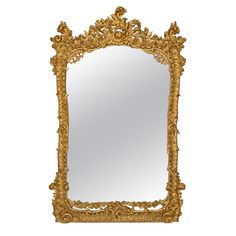 an ornate gold framed mirror against a white background