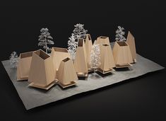 five wooden vases sitting on top of a table next to snow covered trees and bushes