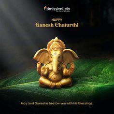 an elephant statue sitting on top of a green leaf covered ground with the words happy ganesh chaturthi