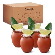 three small glasses with limes and tomatoes in them next to a cardboard box that says contour