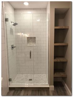 a walk in shower sitting inside of a bathroom