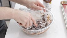 a person mixing food in a bowl on top of a counter