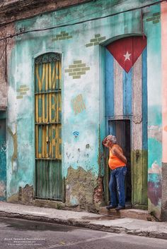 a man standing in the doorway of an old building