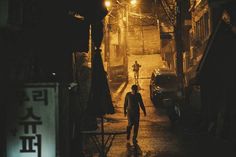 a man walking down a street at night