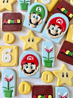 some cookies that are shaped like mario and other items on a table with star decorations