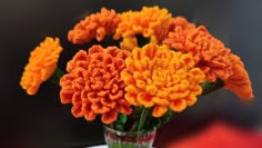 a vase filled with orange and yellow flowers