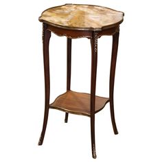 a small wooden table with marble top