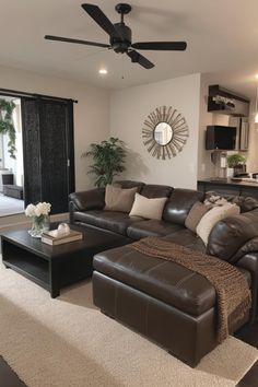 a living room filled with furniture and a ceiling fan