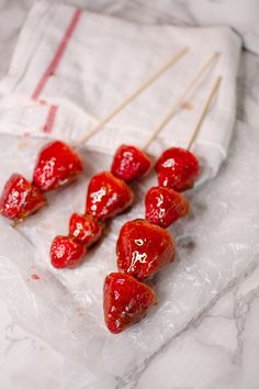 strawberries are arranged on sticks in the shape of hearts