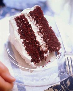 a slice of red velvet cake with white frosting