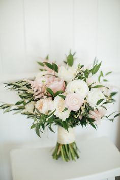 a bouquet of flowers sitting on top of a white table