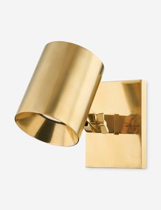 a gold wall light with a white background