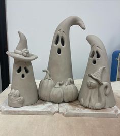 three clay witches sitting on top of a table