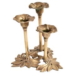 two metal candlesticks with flowers on them