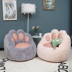 two bean bag chairs with paw prints on the front and back, one in pink and grey