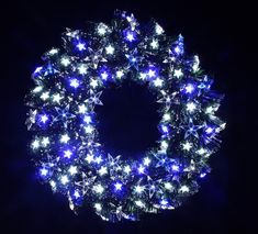 a blue and white wreath with lights on it