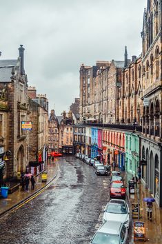 cars parked on the side of a wet street