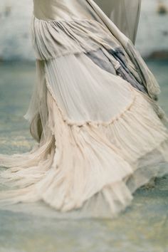 a woman in a white dress holding an umbrella