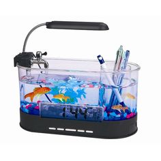 an aquarium with pens, pencils and other items in the bottom half is shown