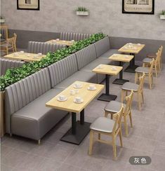 an image of a restaurant setting with plants growing on the wall and tables in the middle