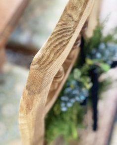 a close up of a wooden spoon with flowers in it