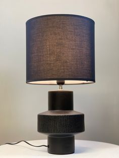 Bold Black Ceramic Table Lamp – Textured Base & Fabric Shade - Decor interiors Lamp With Black Shade, Minimalist Spaces, Monochromatic Design, Stylish Table Lamps, Ceramic Table Lamp, Black Table Lamps, Ceramic Base, Black Shade, Modern Accents