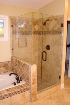 a bath tub sitting next to a walk in shower