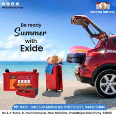 a red car parked on the beach next to an exide battery box and suitcase