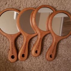 three wooden mirrors sitting on top of a carpeted floor