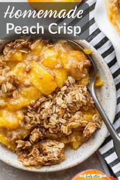 a bowl filled with peach crisp and topped with oatmeal next to an orange