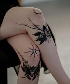 a woman's legs with tattoos on them